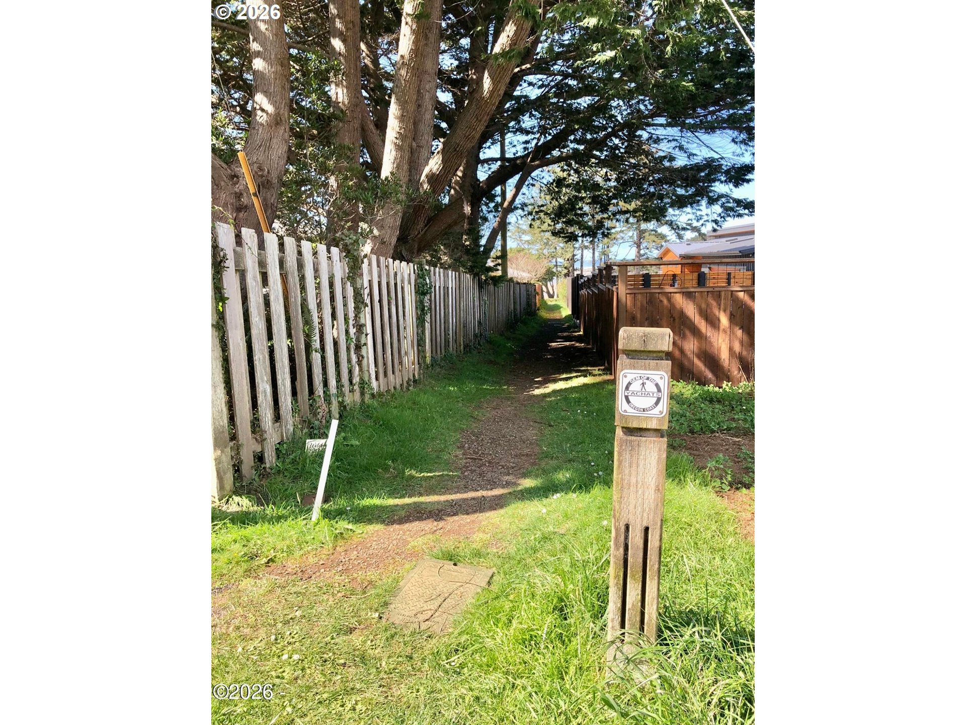 15 Shell Street Yachats, OR 97498 - Photo 43 of 47 a backyard of a house with table and chairs