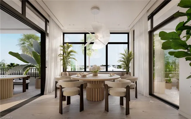 a dining room with furniture a chandelier and a rug