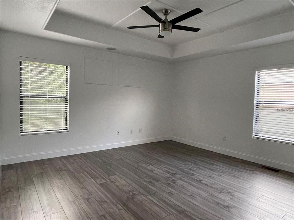 3731 Seneca Club Loop, Unit B Orlando, FL 32808 - Photo 12 of 32 wooden floor in an empty room with a window