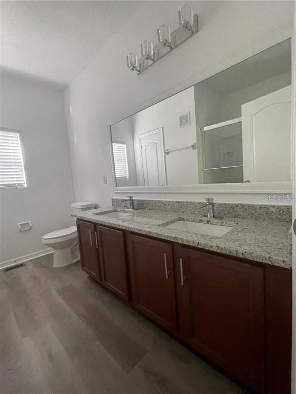 3731 Seneca Club Loop, Unit B Orlando, FL 32808 - Photo 13 of 32 a bathroom with a granite countertop bathtub and double sink