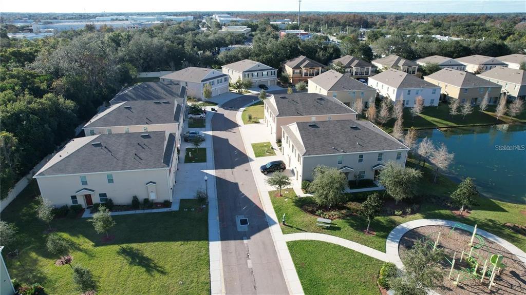 3731 Seneca Club Loop, Unit B Orlando, FL 32808 - Photo 28 of 32 an aerial view of multiple houses with yard