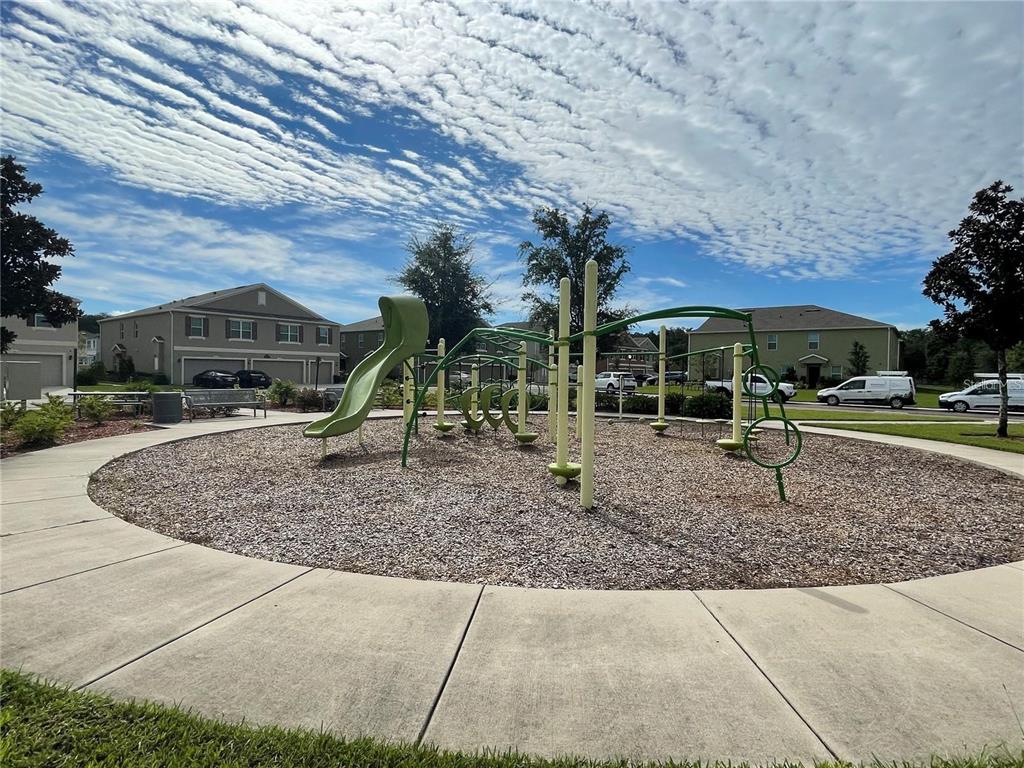 3731 Seneca Club Loop, Unit B Orlando, FL 32808 - Photo 29 of 32 a view of outdoor space with playground and green space