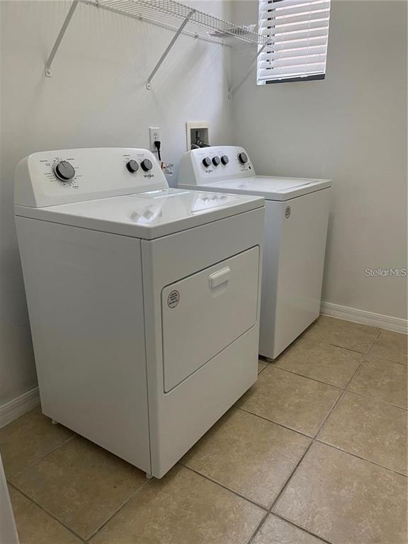 3731 Seneca Club Loop, Unit B Orlando, FL 32808 - Photo 8 of 32 a utility room with dryer and washer