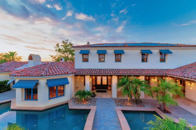 a view of a house with swimming pool and porch