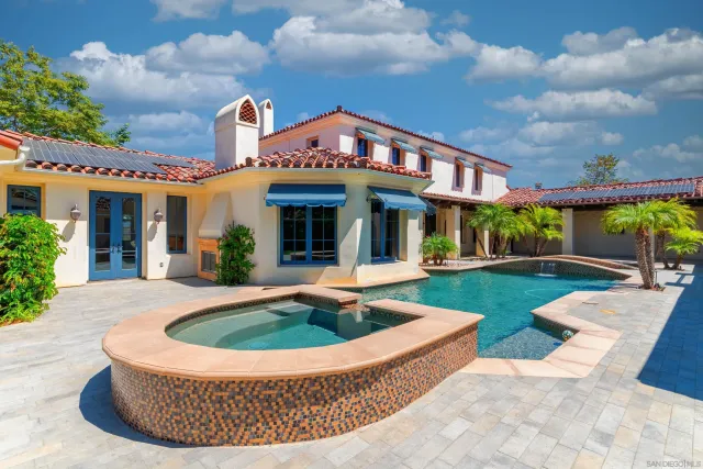 a view of a kitchen with granite countertop lots of counter top space and stainless steel appliances