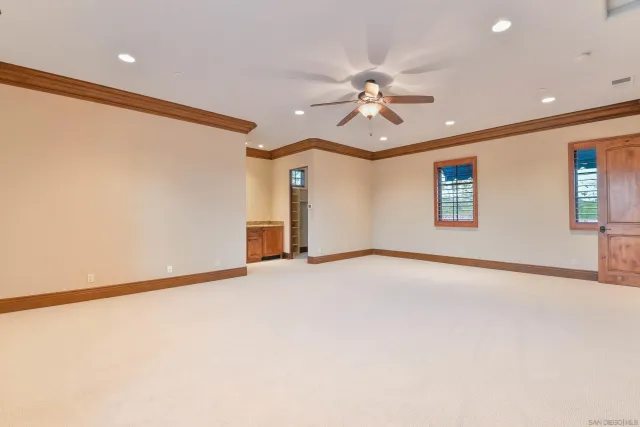 a view of an empty room with a fireplace and a window