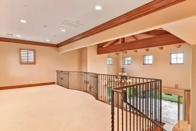 a view of an empty room with a fireplace and a window