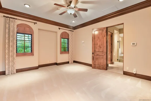 a front view of a house with a yard and potted plants