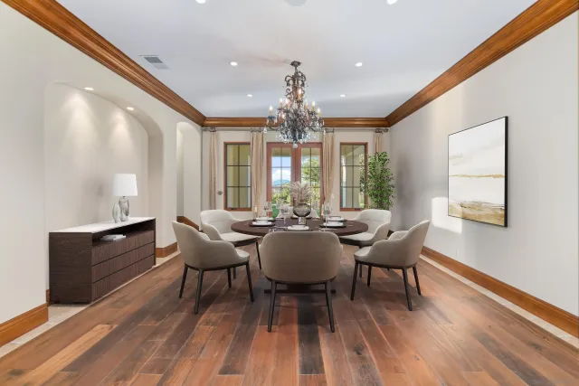 a spacious bedroom with a bed a mirror and a large window