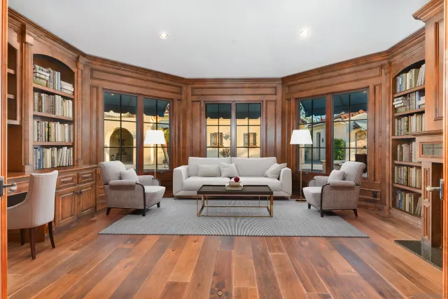 a backyard of a house with plants and barbeque oven