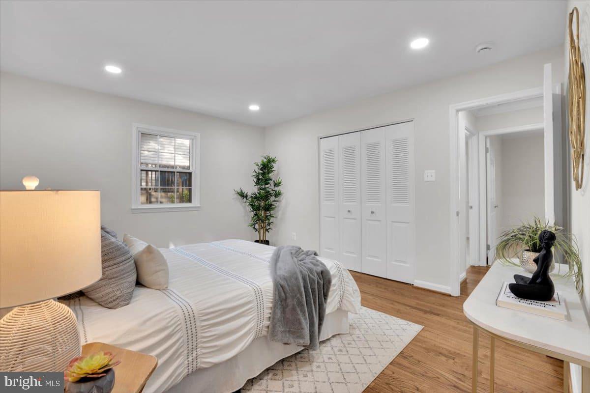 7217 Willow Oak Place Springfield, VA 22153 - Photo 15 of 31 a bedroom with a bed and wooden floor