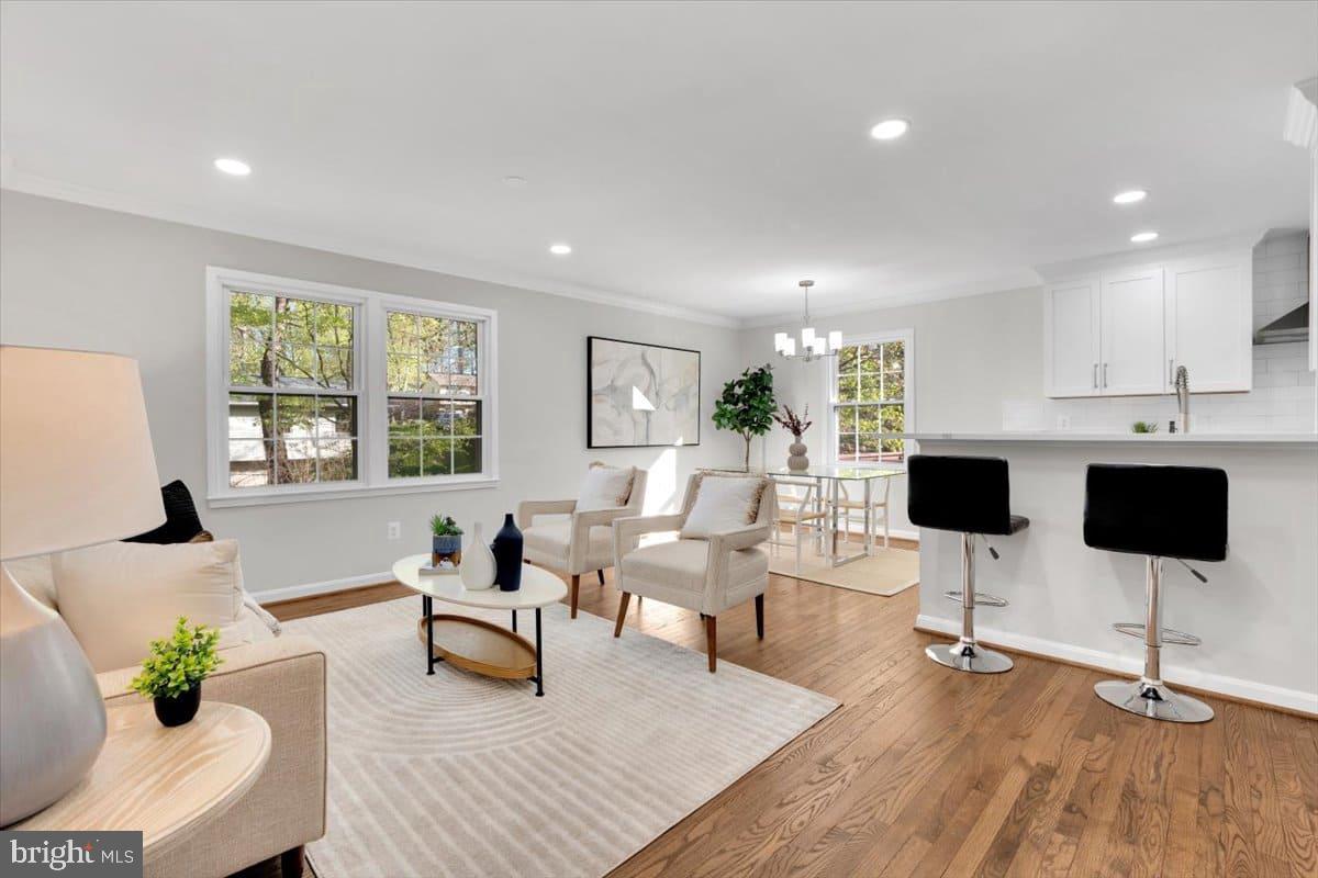 7217 Willow Oak Place Springfield, VA 22153 - Photo 2 of 31 a living room with furniture a flat screen tv and a large window