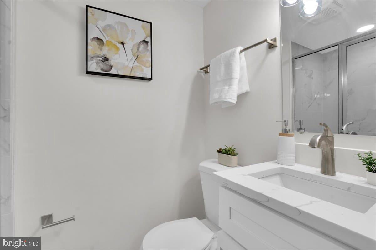 7217 Willow Oak Place Springfield, VA 22153 - Photo 21 of 31 a bathroom with a sink mirror and toilet