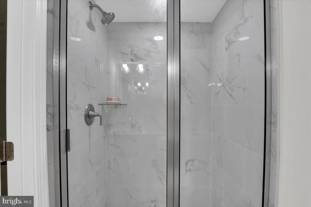 7217 Willow Oak Place Springfield, VA 22153 - Photo 22 of 31 a bathroom with a glass shower door