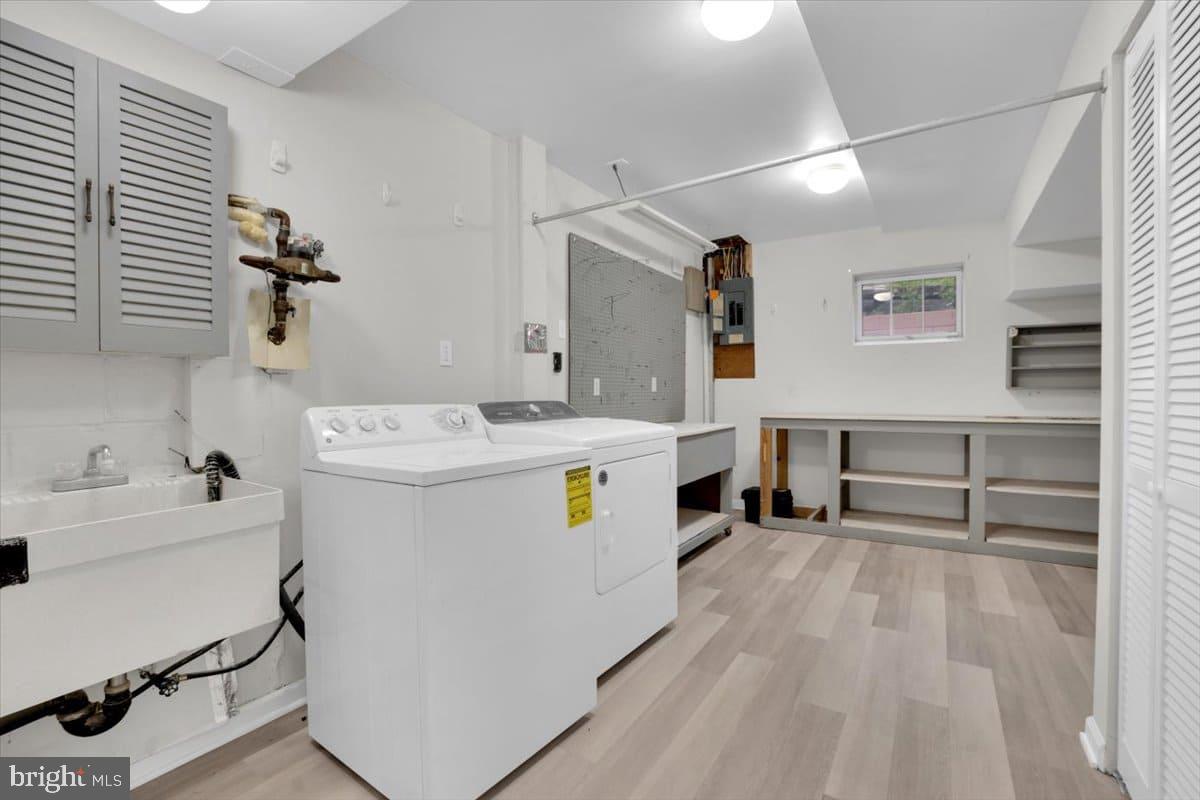 7217 Willow Oak Place Springfield, VA 22153 - Photo 26 of 31 a utility room with cabinets dryer and washer