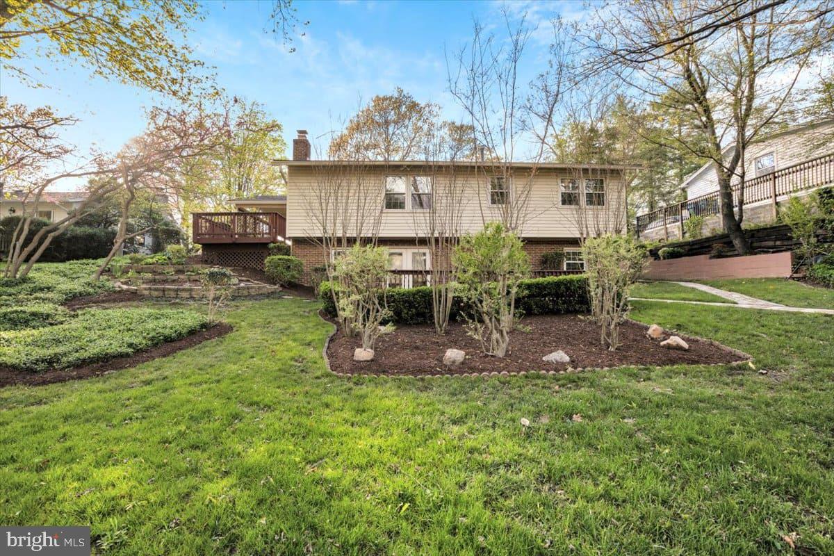 7217 Willow Oak Place Springfield, VA 22153 - Photo 29 of 31 a view of a backyard with table and chairs potted plants and large tree