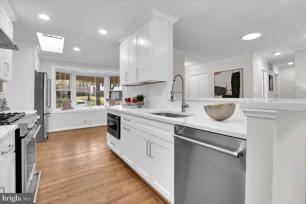 7217 Willow Oak Place Springfield, VA 22153 - Photo 6 of 31 a kitchen with counter top space cabinets and appliances