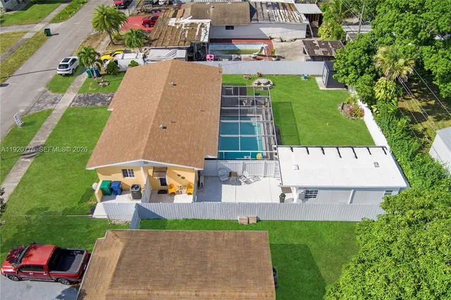 an aerial view of a house with a garden and swimming pool