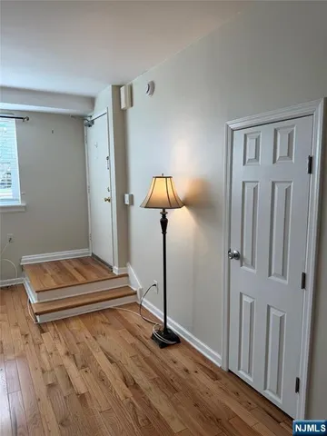 a view of a room with wooden floor and stairs