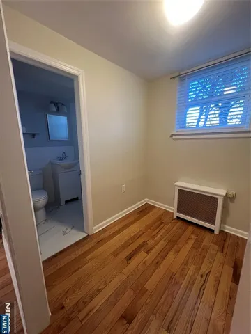 a view of a room with wooden floor and a sink