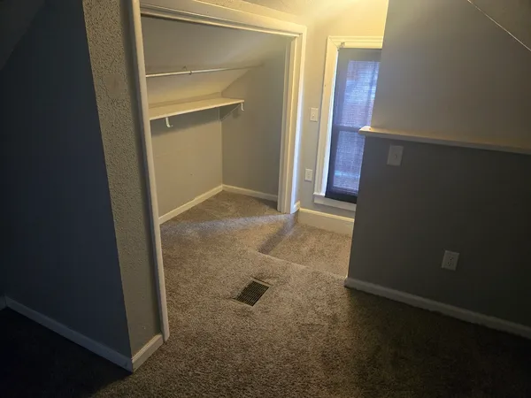 an empty room with windows and entrance