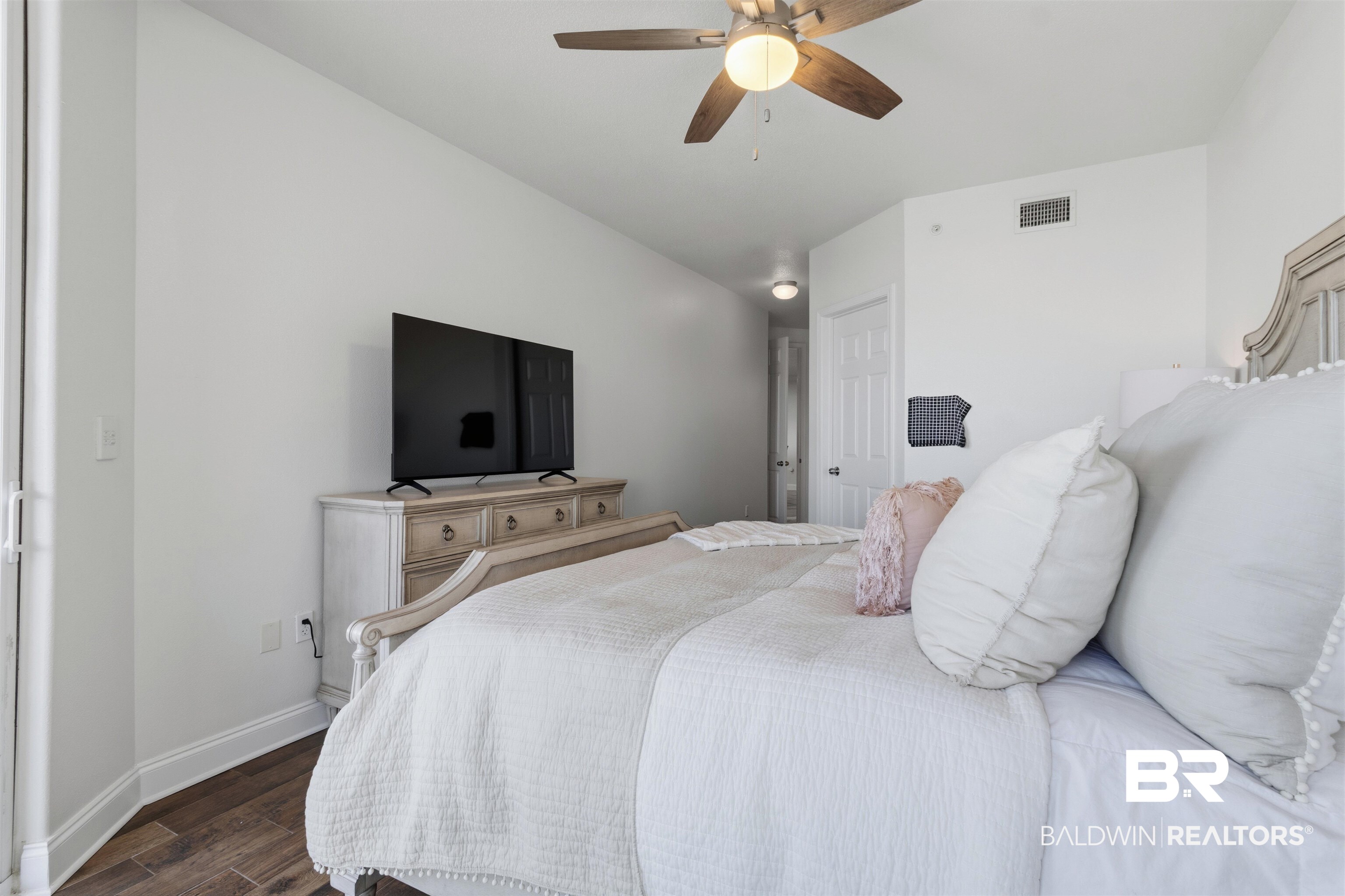 3564 Bayou Road, Unit 203 Orange Beach, AL 36561 - Photo 25 of 53 Interior room featuring wood-finish flooring, white painted walls, and a ceiling fan with integrated lighting