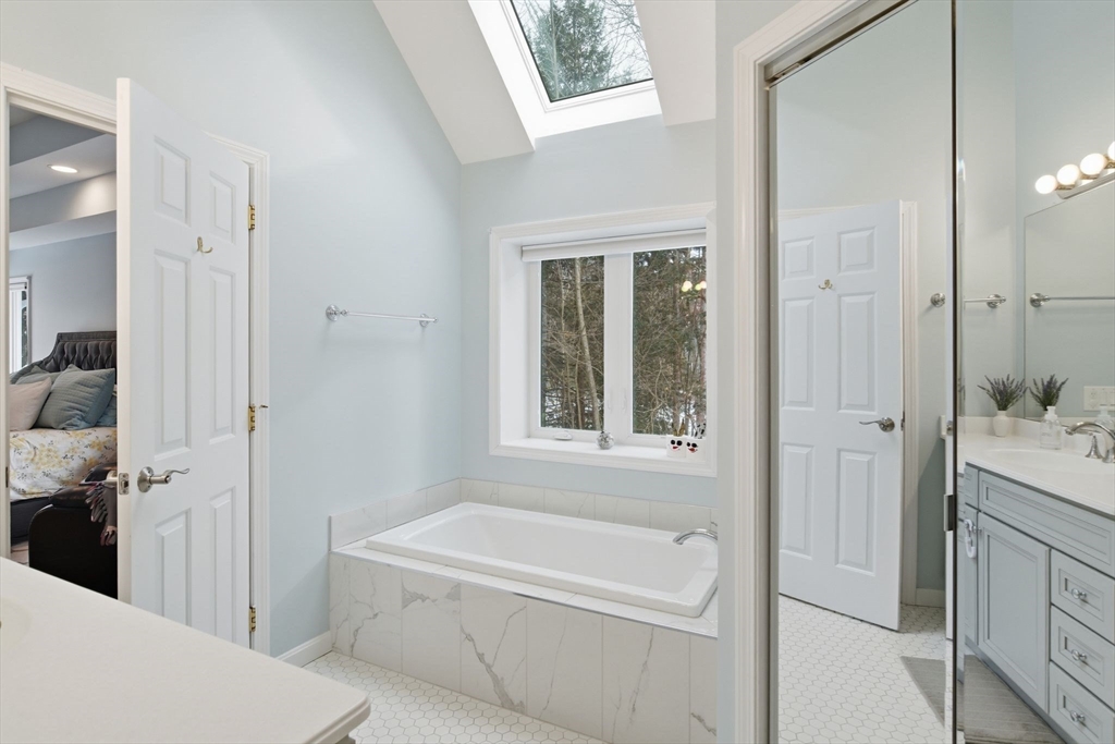 6 Shattuck Road Hadley, MA 01035 - Photo 23 of 40 a bathroom with a tub a sink and a large mirror