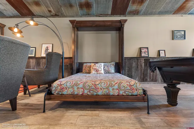 a en suite bathroom with a granite countertop sink and a mirror