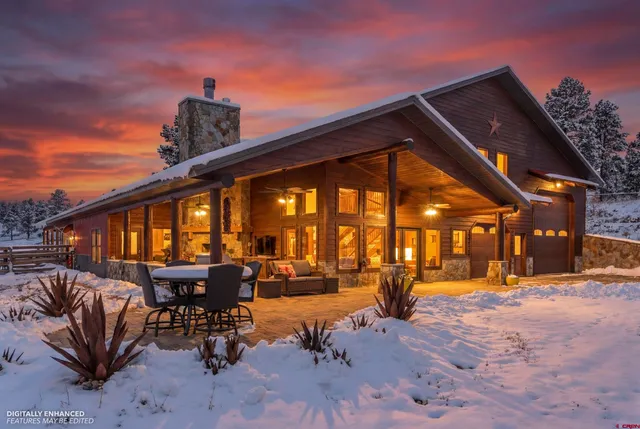 a living room with furniture a lamp and large window