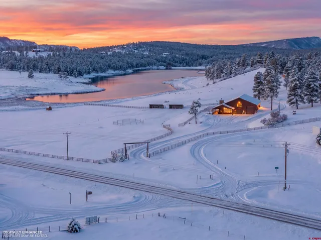 a view of a brick building with floor to ceiling windows and wooden floor