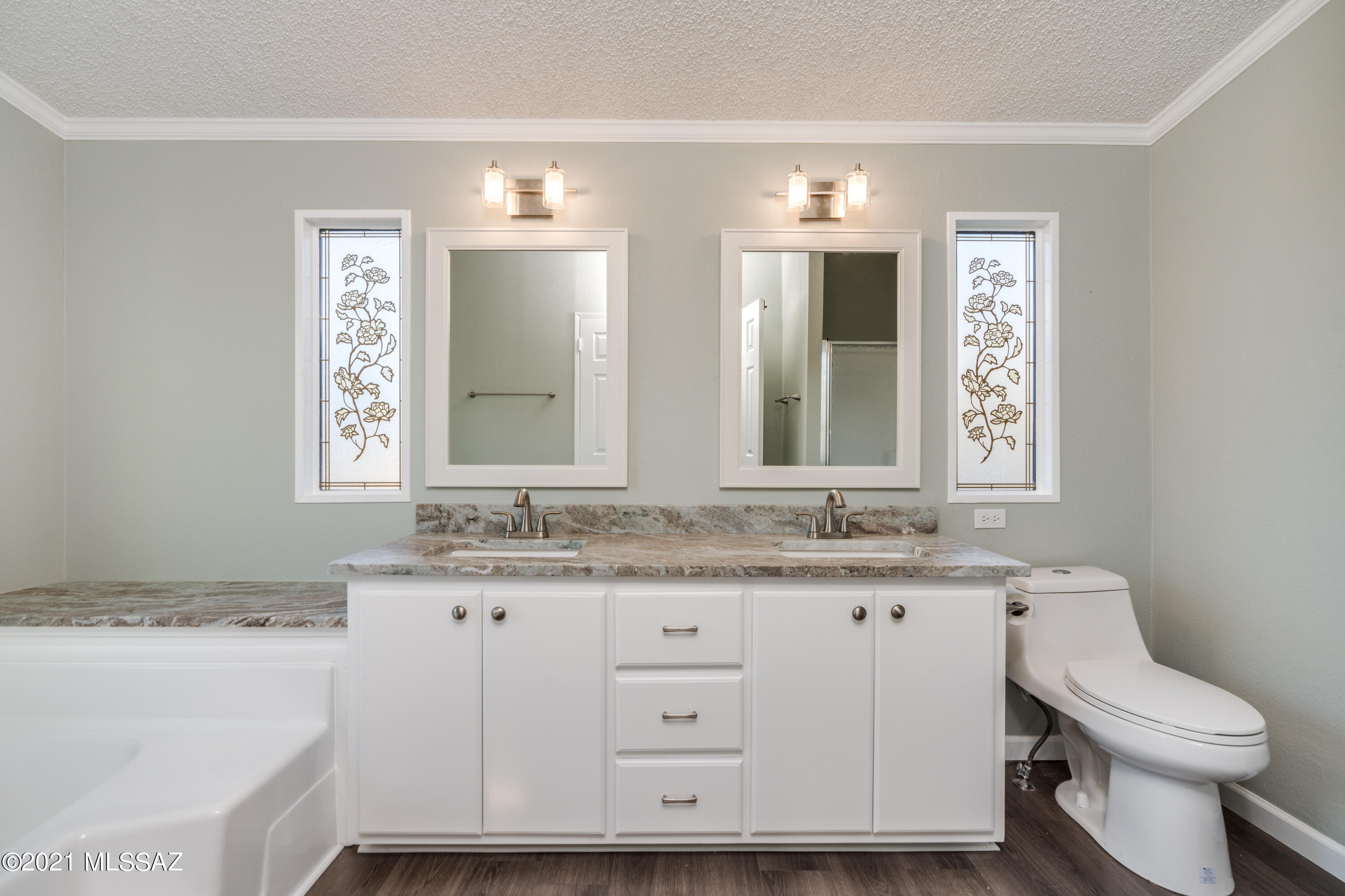 4489 East Wilds Road Tucson, AZ 85739 - Photo 38 of 50 a bathroom with a granite countertop toilet sink and mirror