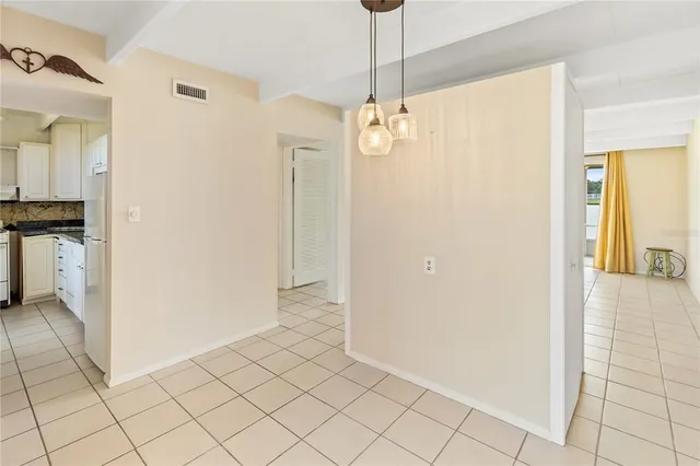 a view of a hallway with chandelier and entryway