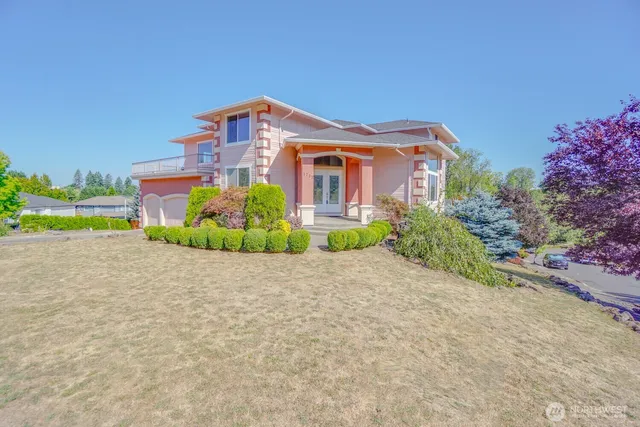 a front view of a house with a yard and a garage