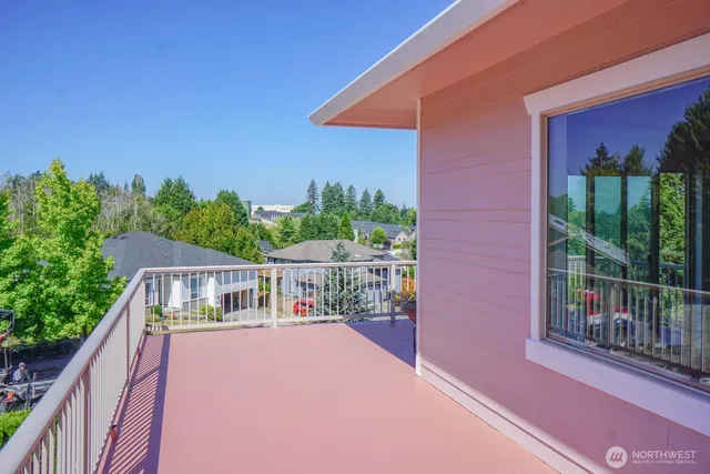 a balcony with tall trees in front of it