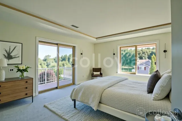 a bedroom with a bed and large window