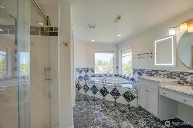 a bathroom with a double vanity sink toilet and shower