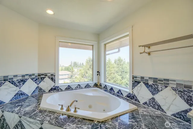 a bath tub sitting in a bathroom next to a window