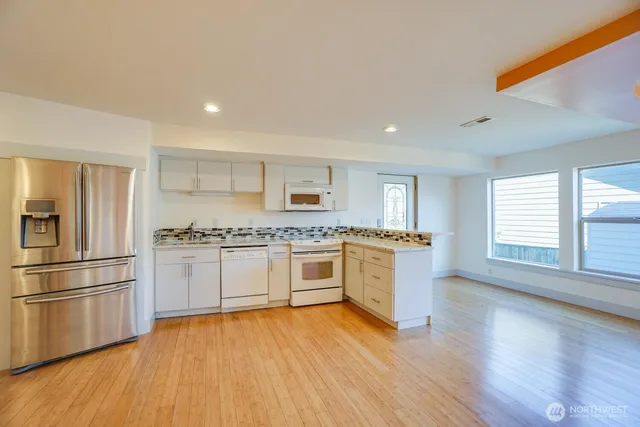 a view of a kitchen with a sink and a refrigerator