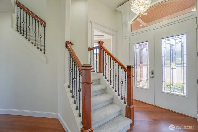a view of an entryway with wooden floor