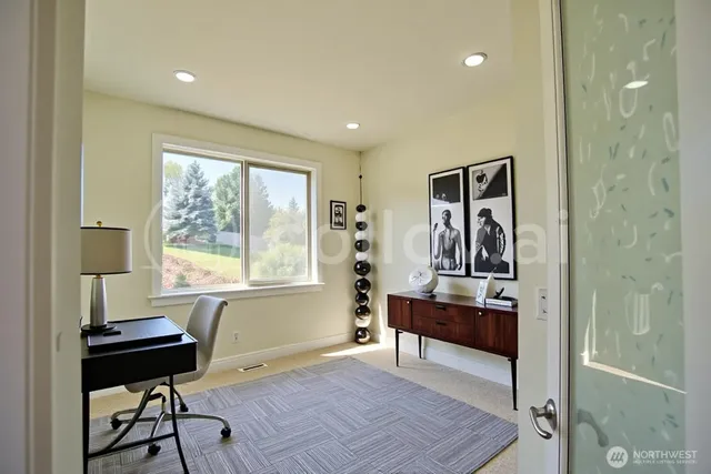 a view of a workspace with furniture and a window