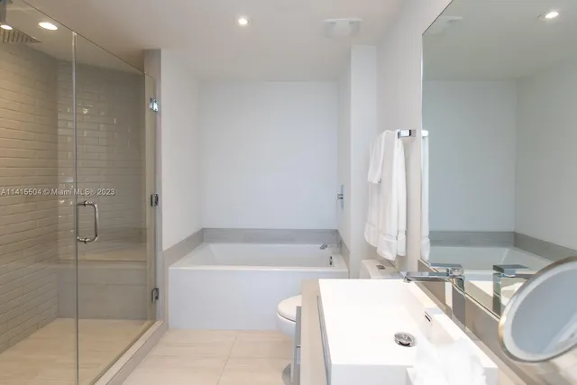 a bathroom with a bathtub and a shower