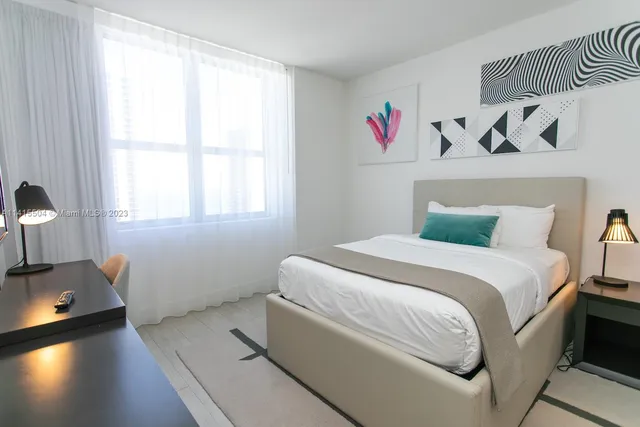 a bed room with a bed and a window