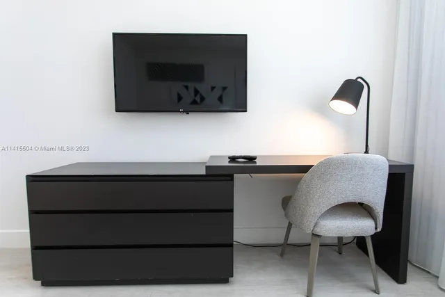 a living room with a chair and a flat screen tv