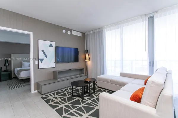 a living room with furniture and a large window