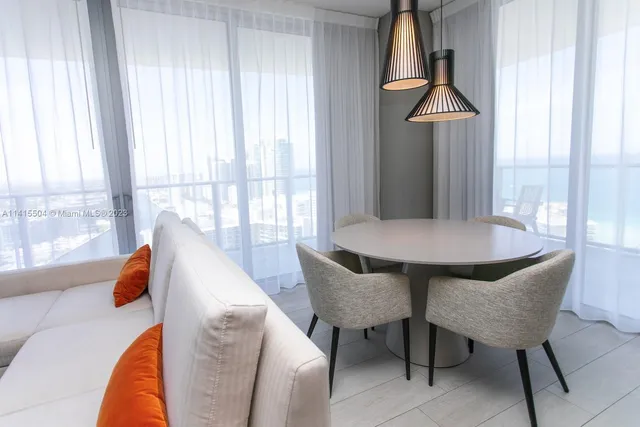 a view of a dining room with furniture and a window