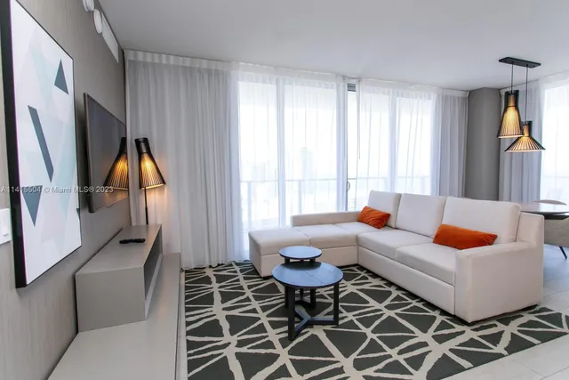 a living room with furniture a rug and a window