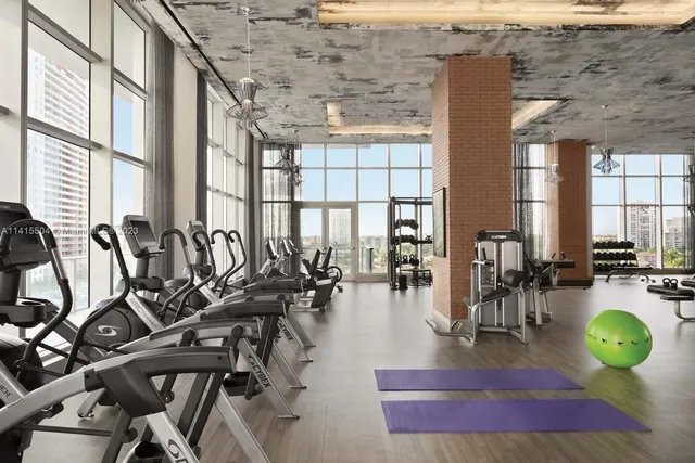 a gym with lots of gym equipment