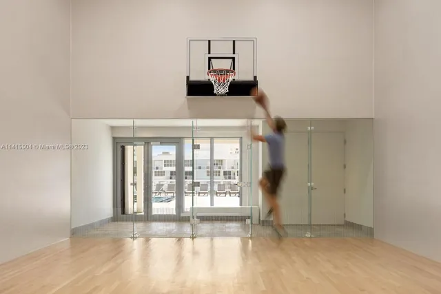 a tennis court with view of palm trees