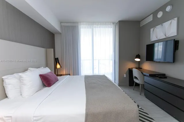 a bedroom with a bed dresser and a window