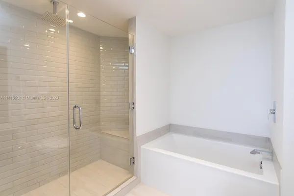 a bathroom with a bathtub and shower